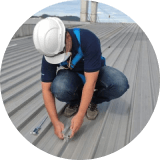 Man in hard hat working on roof